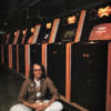 Tim Skelly poses with Reactor cabinets, an arcade video game by Gottlieb 1982 Tim Skelly